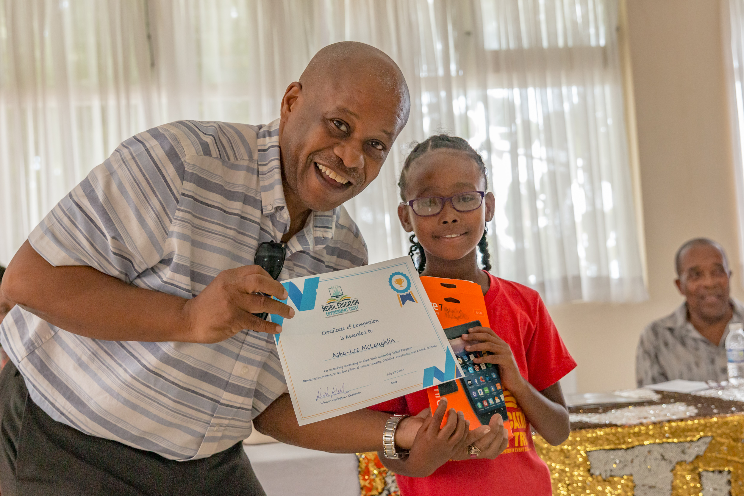 Student Receives certificate and Tablet