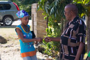 Winston Wellington handing out food ticket