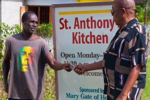 Winston Wellington handing out food ticket