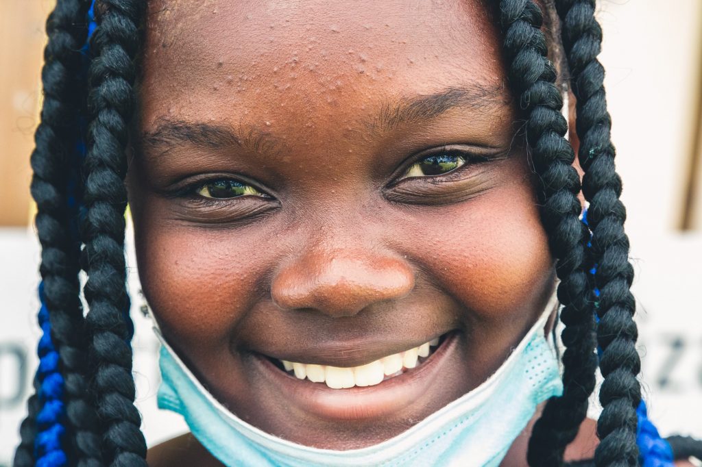 Young Girl with Mask Looking into Camera