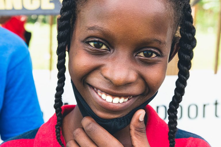 Young Girl with Mask Looking into Camera
