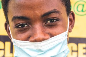 Young Boy with Mask Looking into Camera